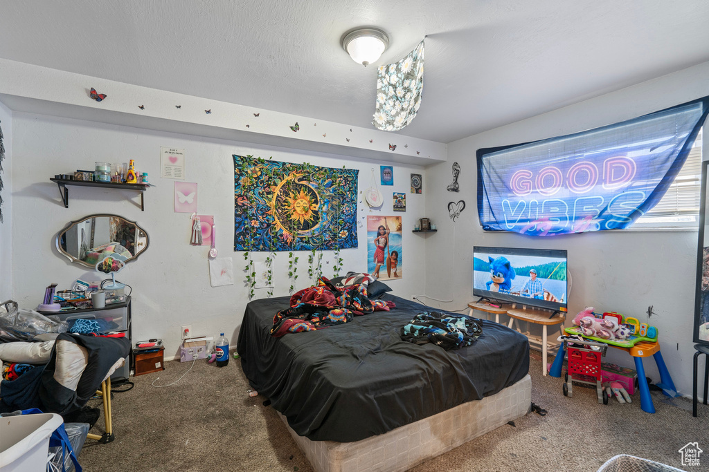 Carpeted bedroom featuring a textured ceiling