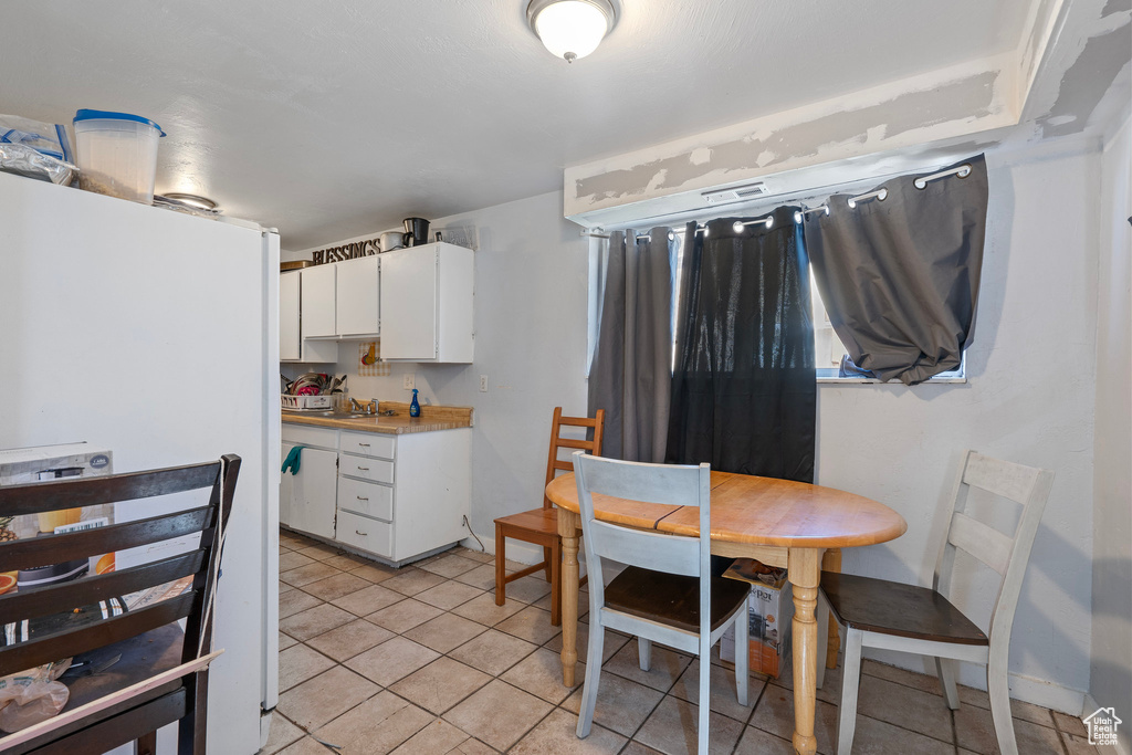 Dining room with light tile patterned floors
