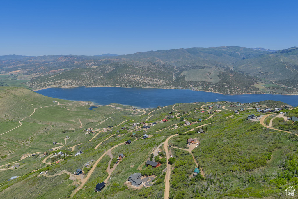 View of property location featuring a water and mountain view