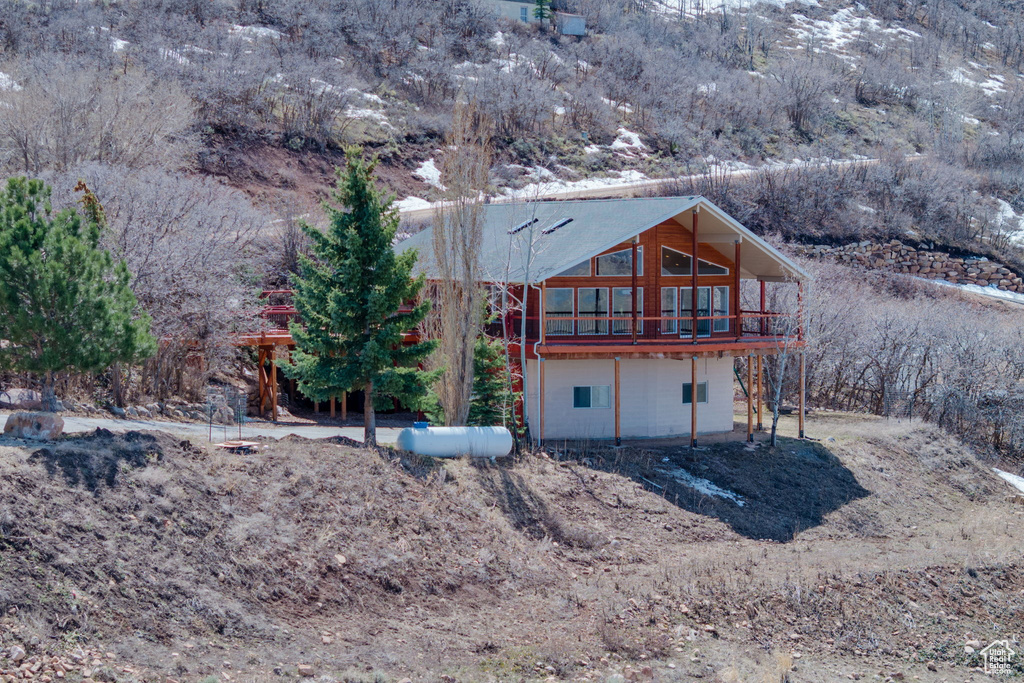 Back of property with a wooden deck