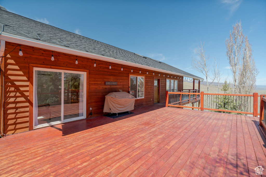 Wooden terrace featuring area for grilling