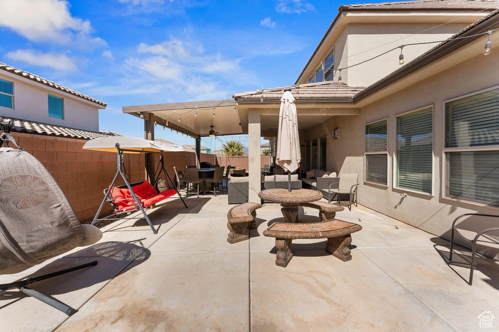 View of patio / terrace with outdoor dining area, an outdoor hangout area, and fence