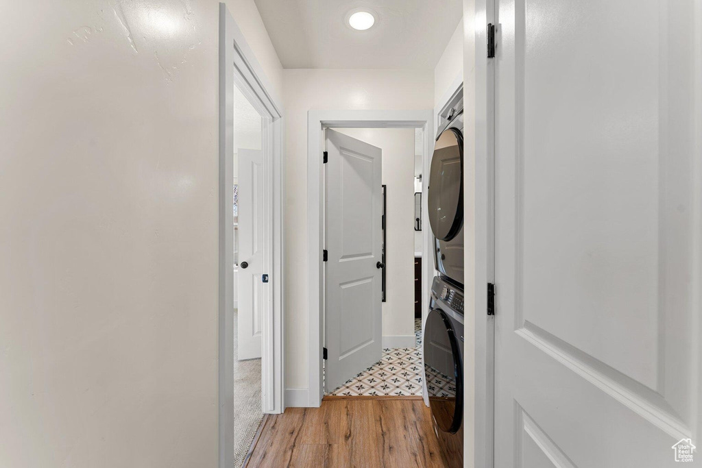 Hall featuring stacked washer / dryer and light wood-style flooring