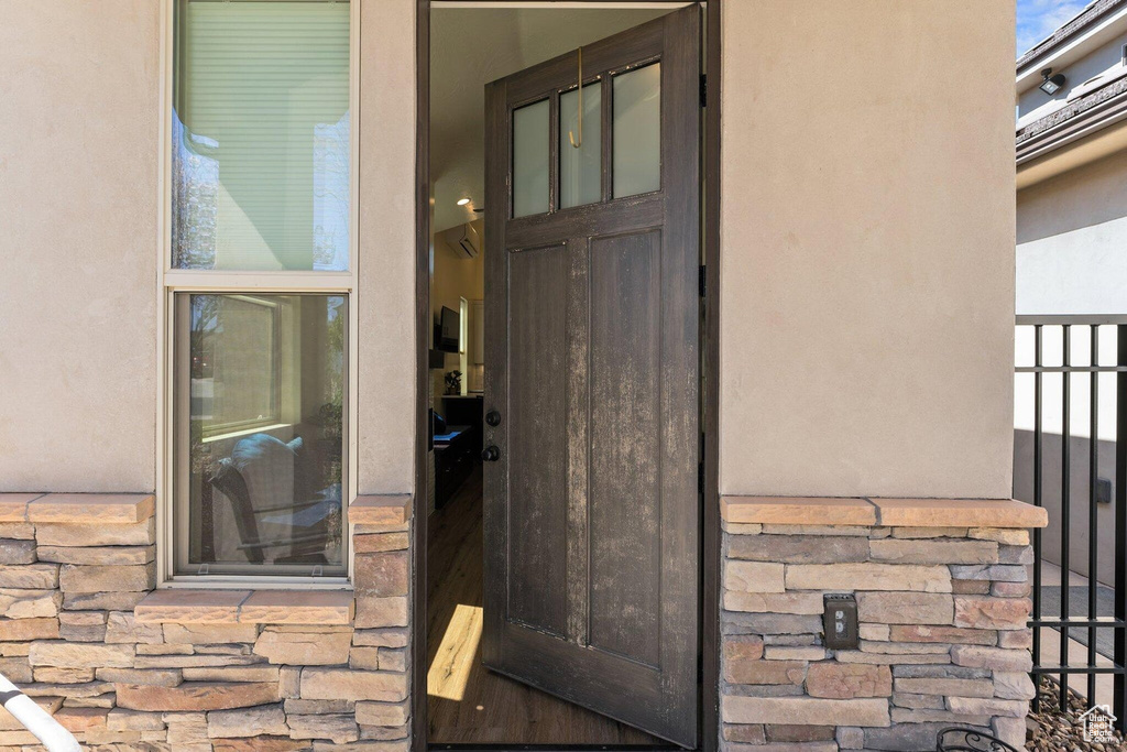 Property entrance with stucco siding and stone siding