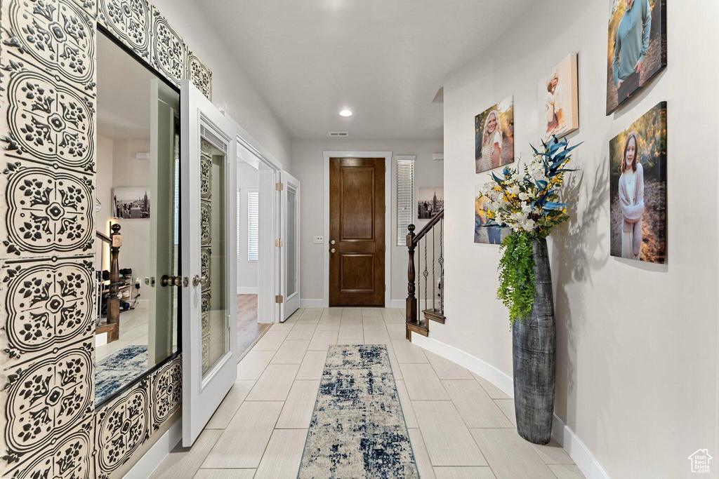Interior space with visible vents, baseboards, stairway, and recessed lighting