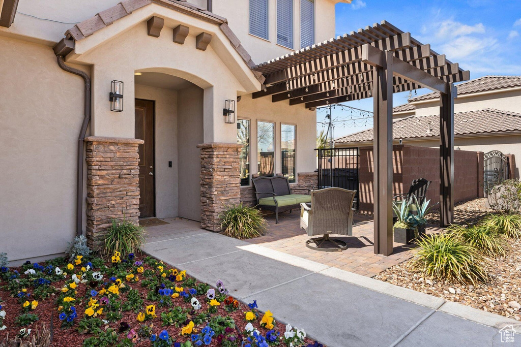 View of patio with fence and a pergola