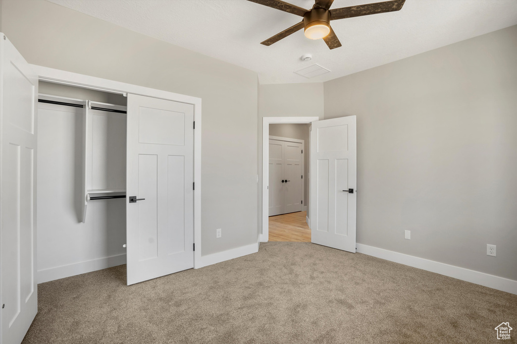 Unfurnished bedroom featuring carpet, baseboards, a closet, and ceiling fan