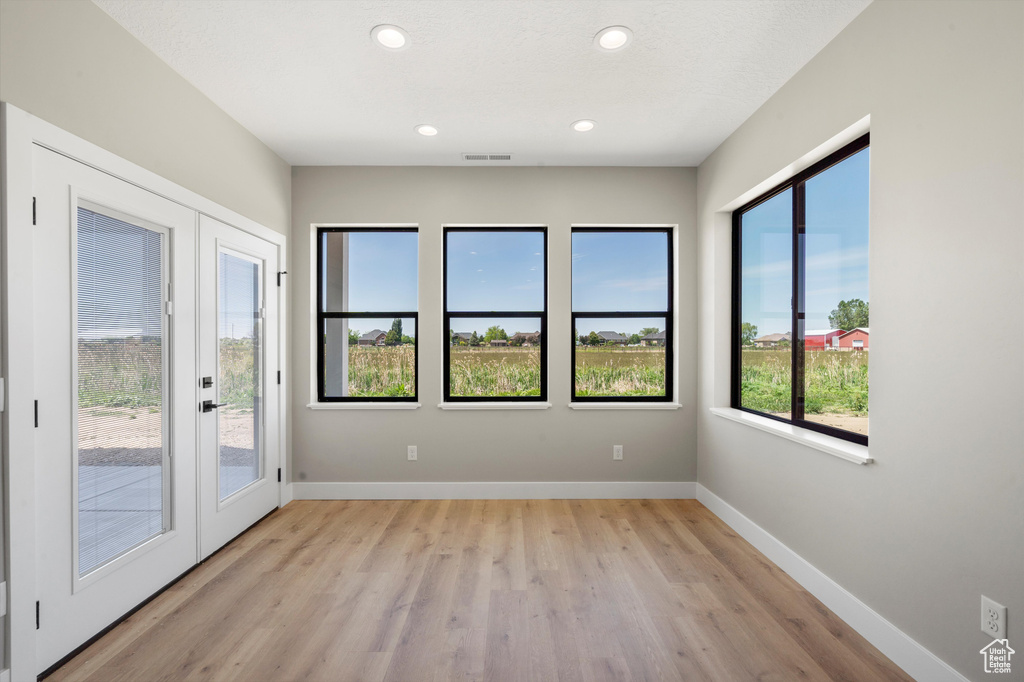 Spare room with light wood-style flooring, baseboards, and recessed lighting
