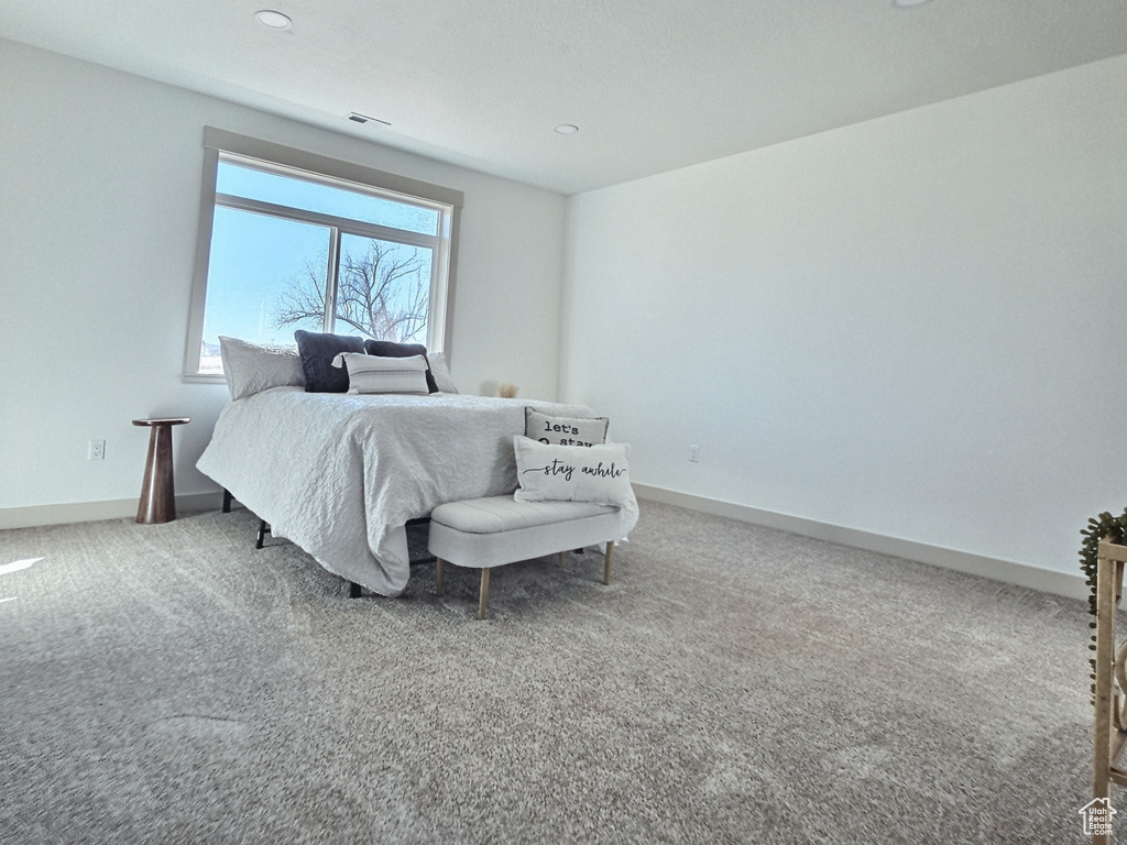 Bedroom featuring carpet floors, baseboards, and visible vents