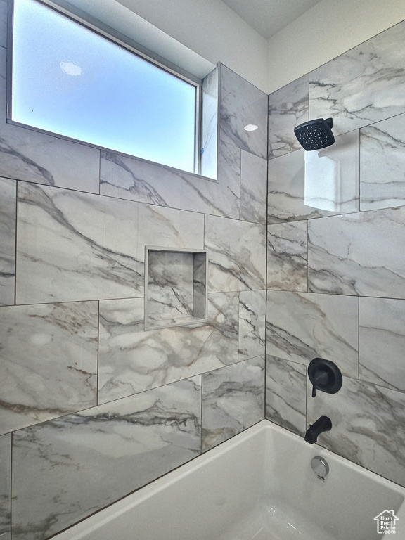 Full bathroom featuring tub / shower combination and a healthy amount of sunlight