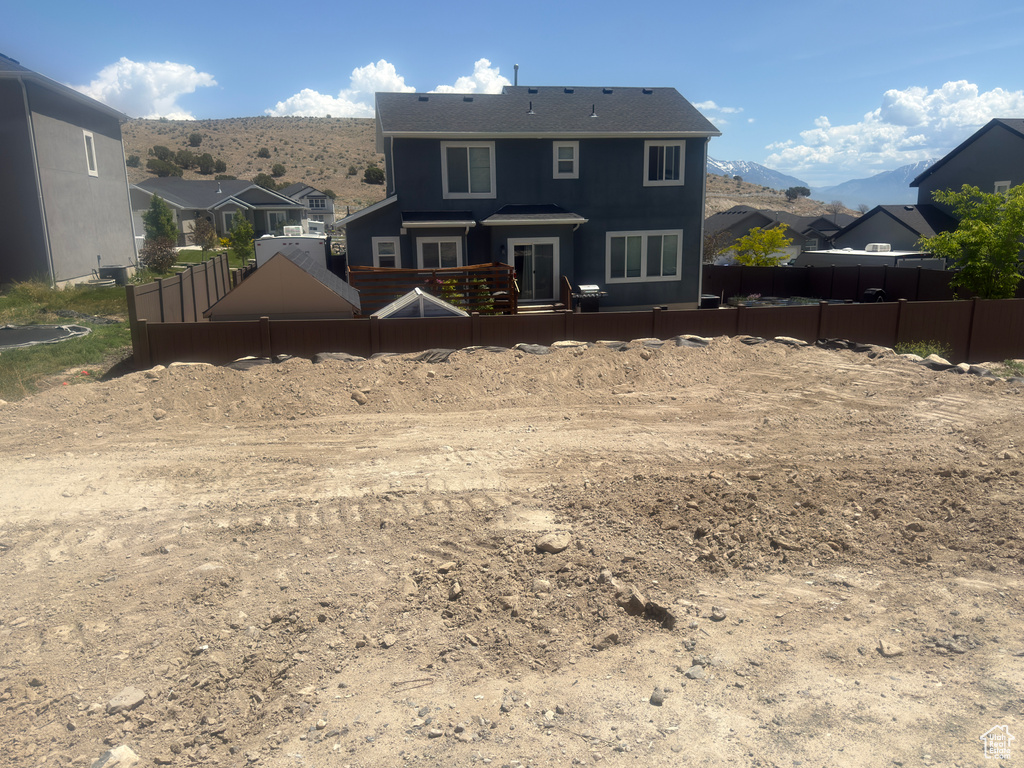 Rear view of house with a mountain view and a residential view