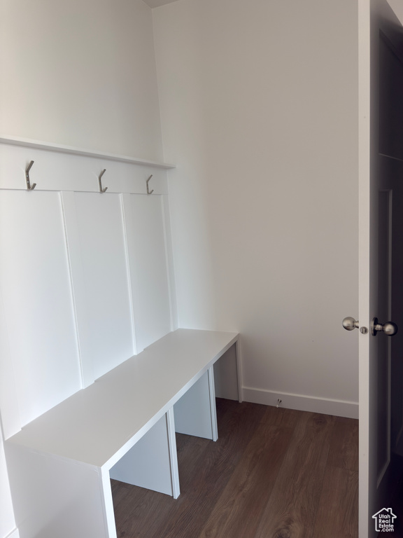 Mudroom featuring dark wood-style floors and baseboards