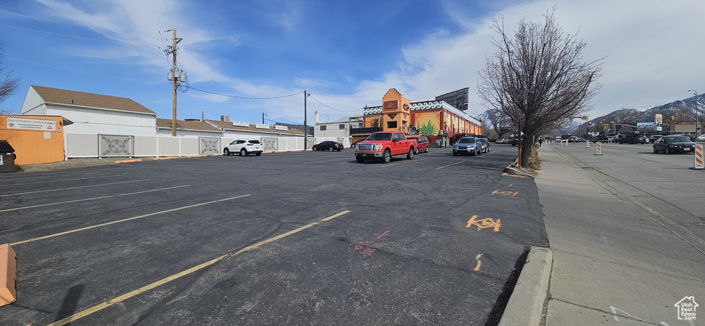 Uncovered parking lot featuring fence