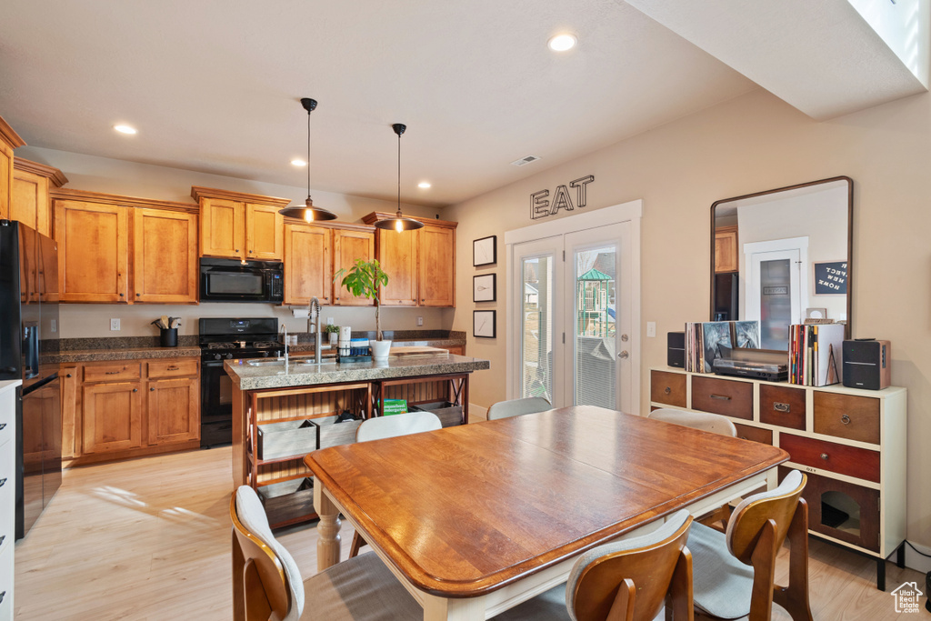 Dining space with visible vents, light wood-style flooring, and recessed lighting