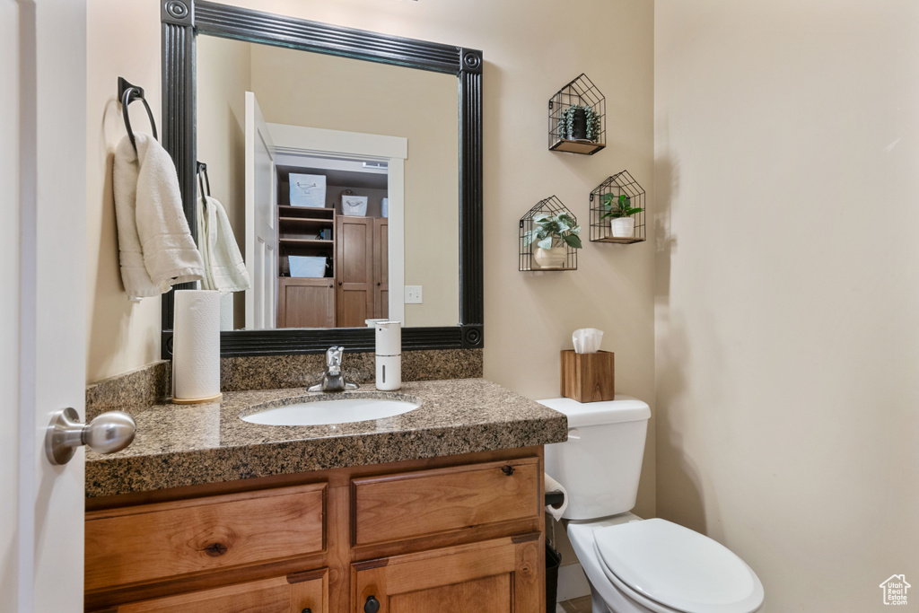Half bathroom featuring toilet and vanity