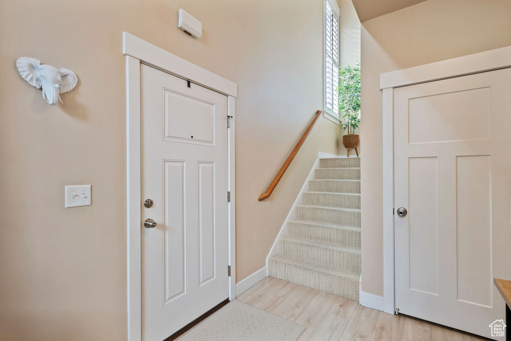 Staircase featuring baseboards and wood finished floors