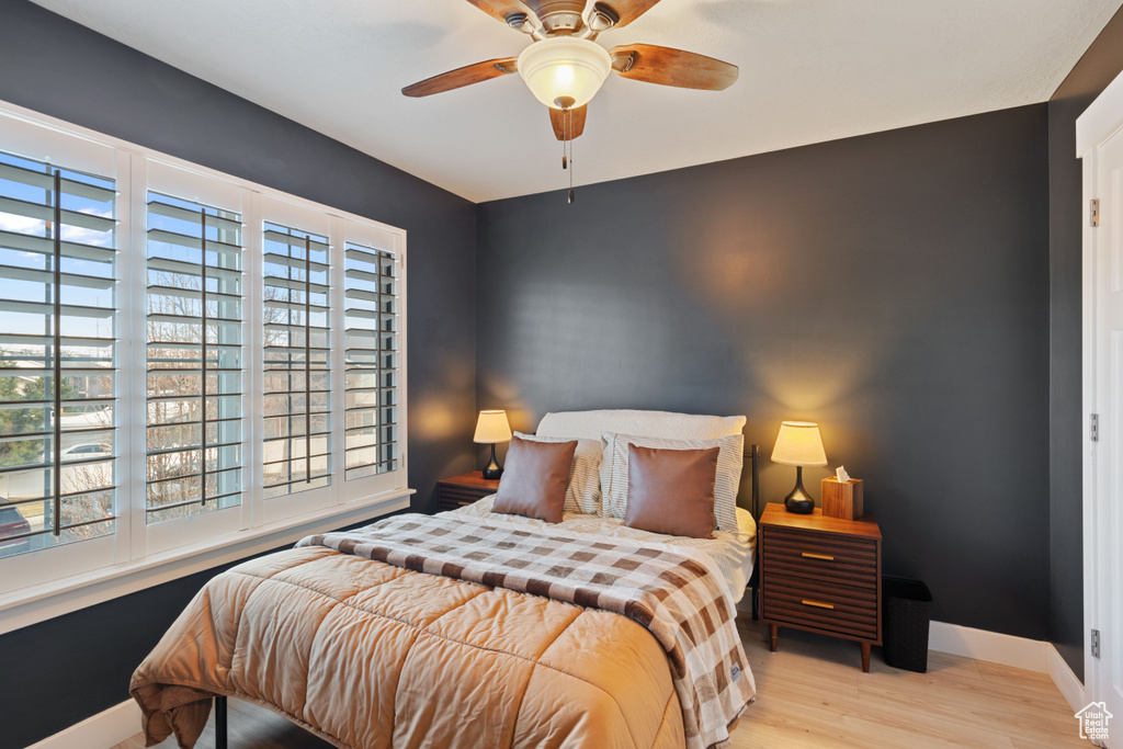 Bedroom with baseboards, ceiling fan, and wood finished floors