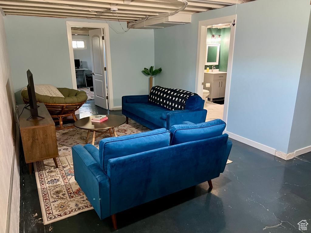Living room with concrete flooring and baseboards
