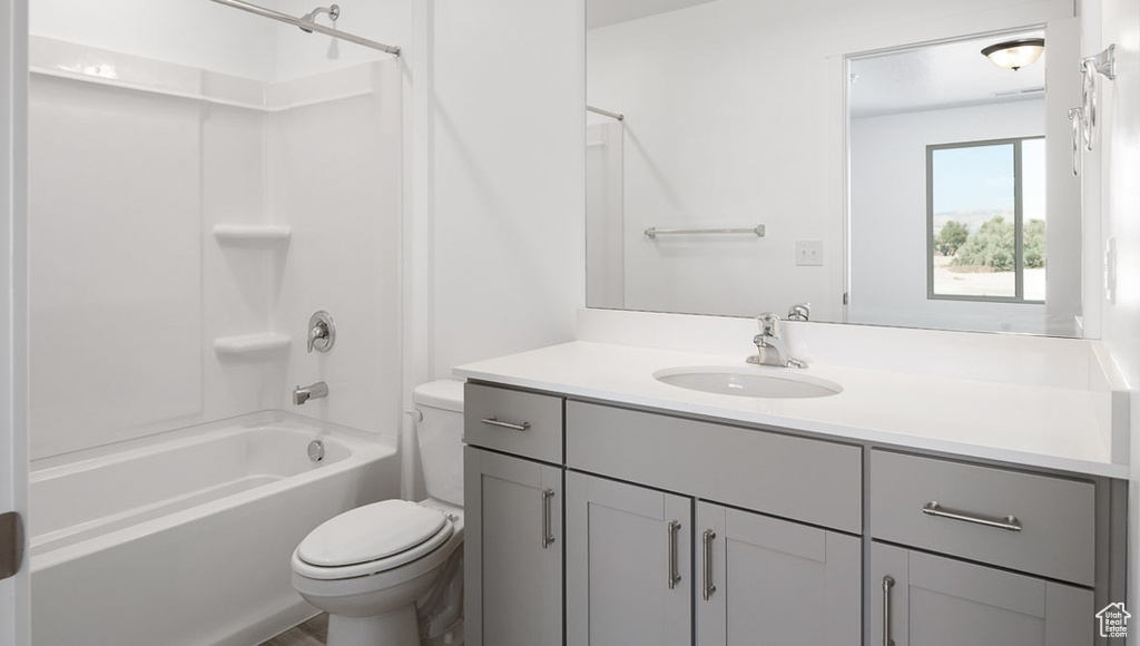 Full bathroom with toilet, vanity, and  shower combination