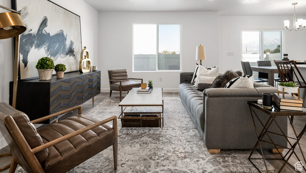 Living room featuring baseboards and a chandelier