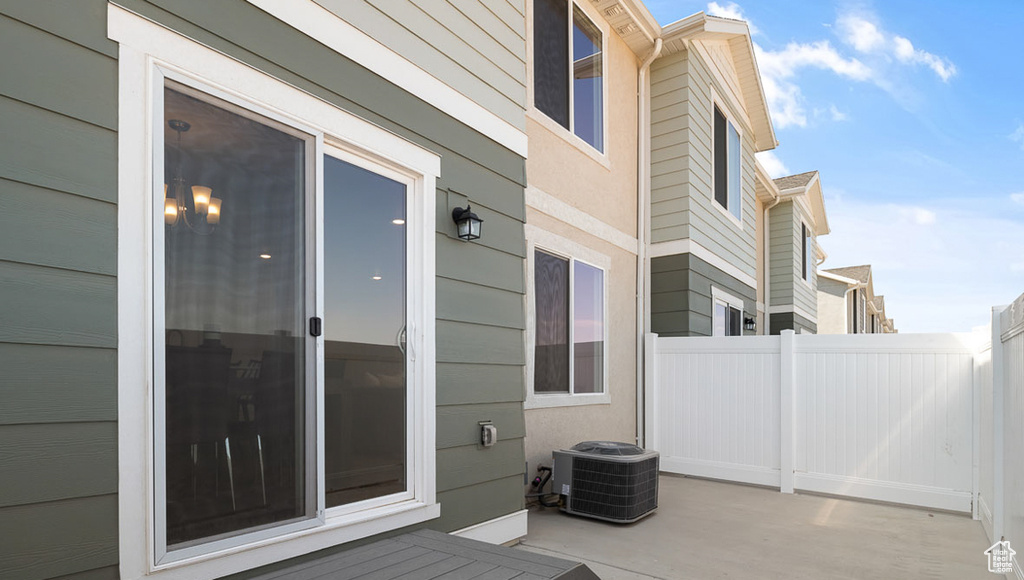 View of patio / terrace featuring central AC and fence