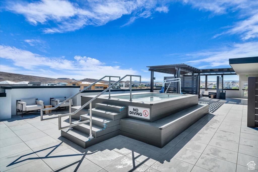 View of patio / terrace with a pergola and an outdoor hot tub