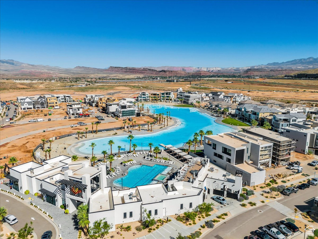 Drone / aerial view of a pool and a mountain backdrop
