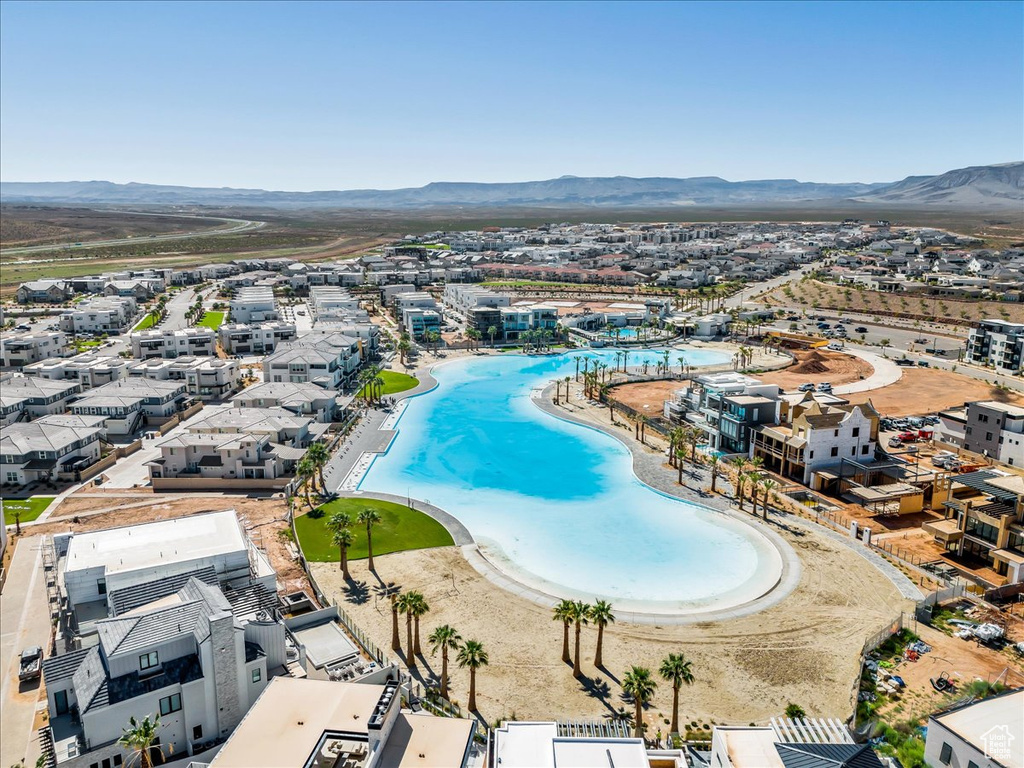 Aerial view of residential area with a mountain backdrop and a pool