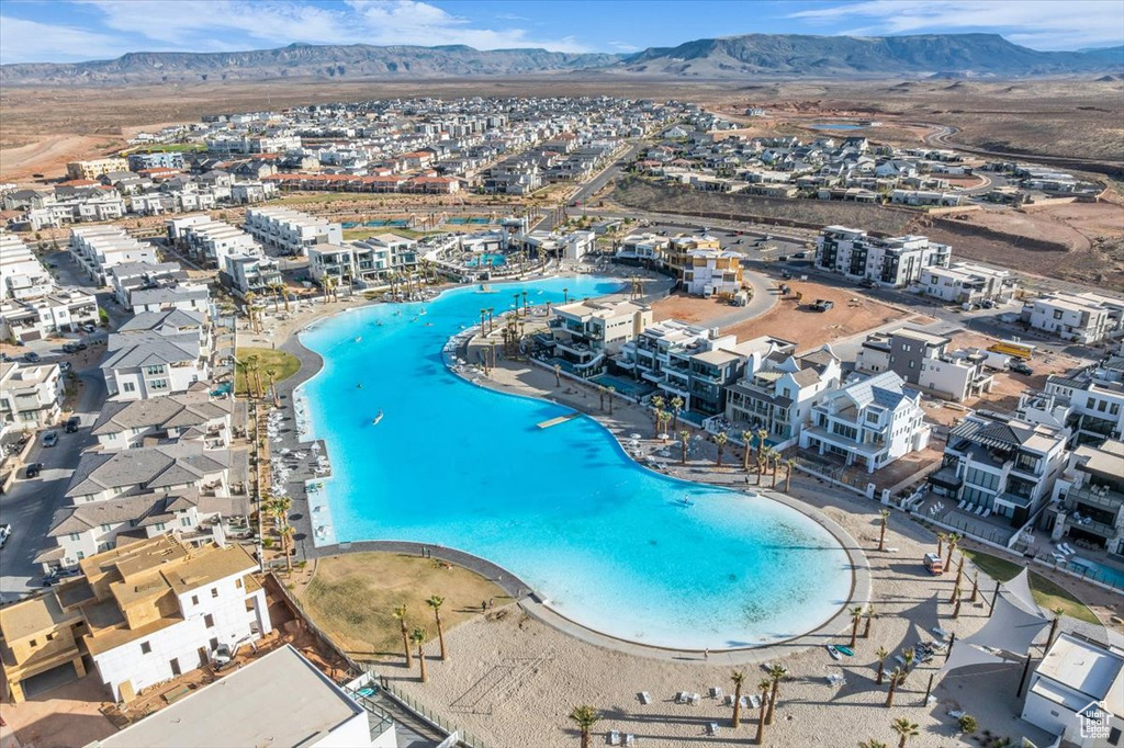Drone / aerial view of a mountain backdrop and a pool area