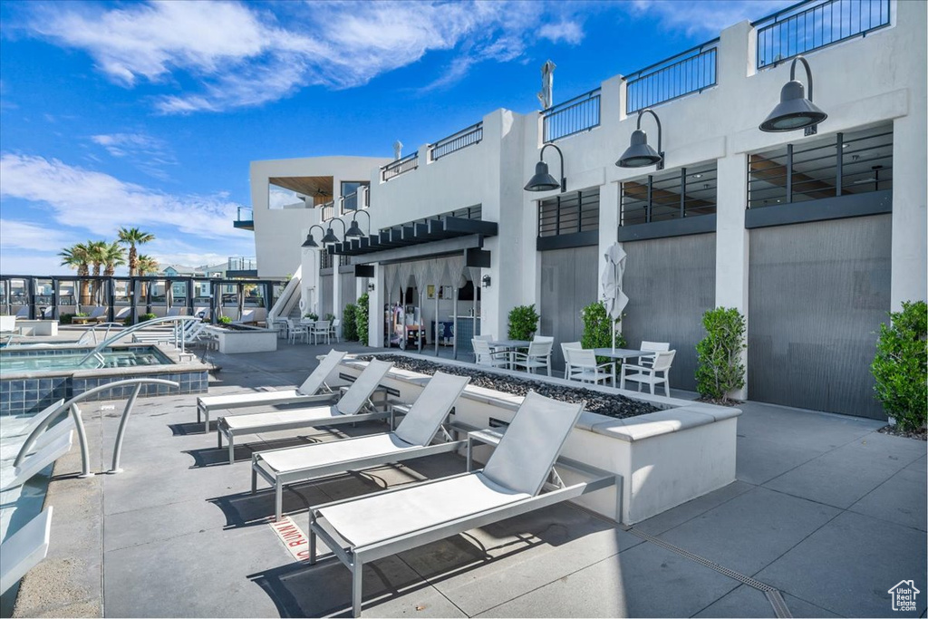 View of patio with a fire pit and a community pool