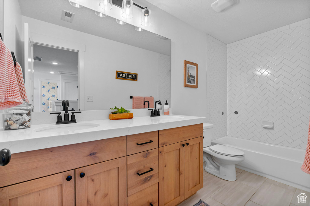 Full bath featuring double vanity, visible vents, a sink, and toilet