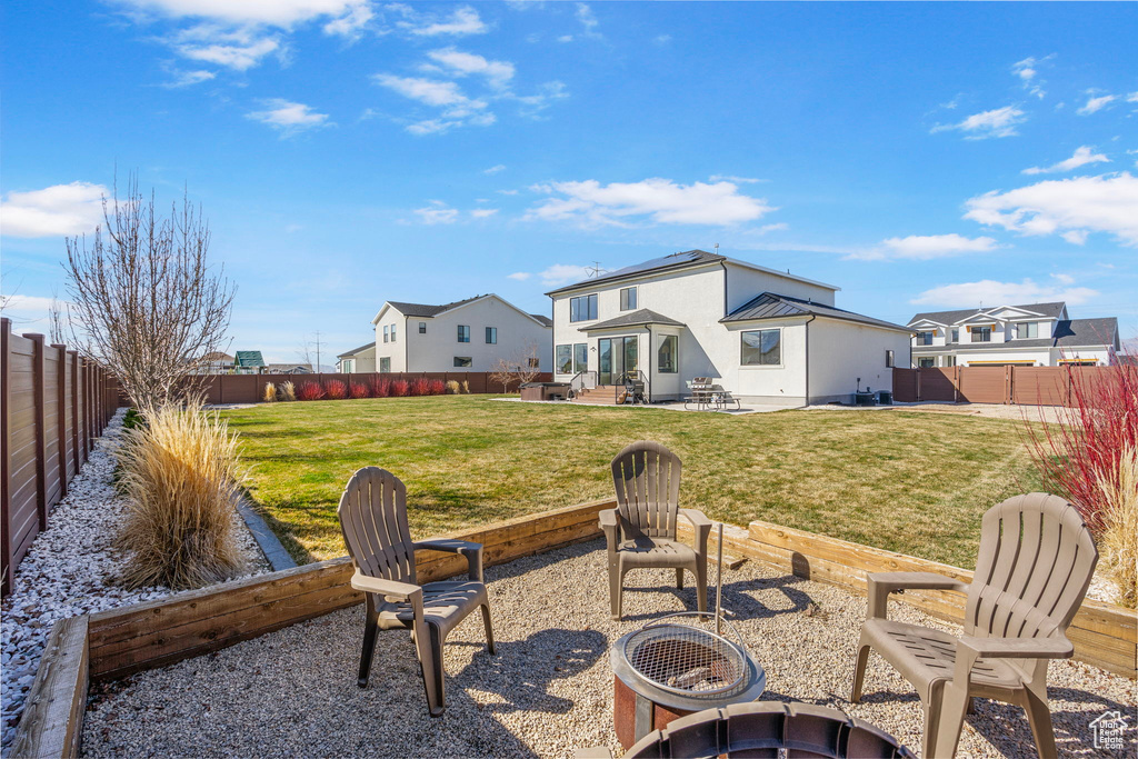 View of yard with a patio, a fenced backyard, and a residential view