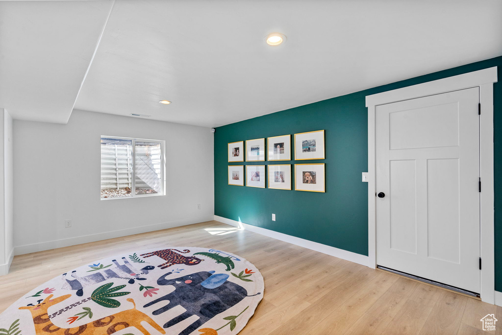 Interior space with baseboards, light wood-style flooring, and recessed lighting