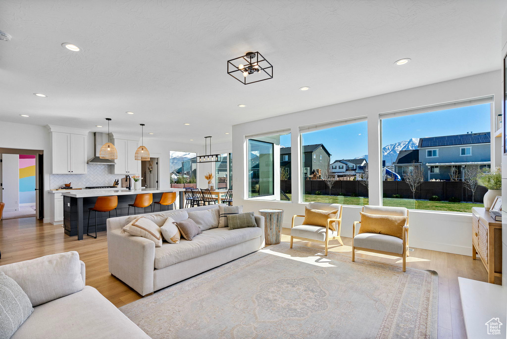 Living area featuring a wealth of natural light, recessed lighting, and light wood finished floors