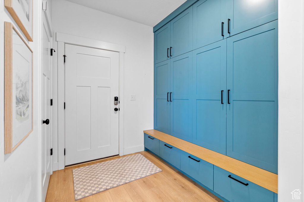 Mudroom featuring baseboards and light wood-style floors
