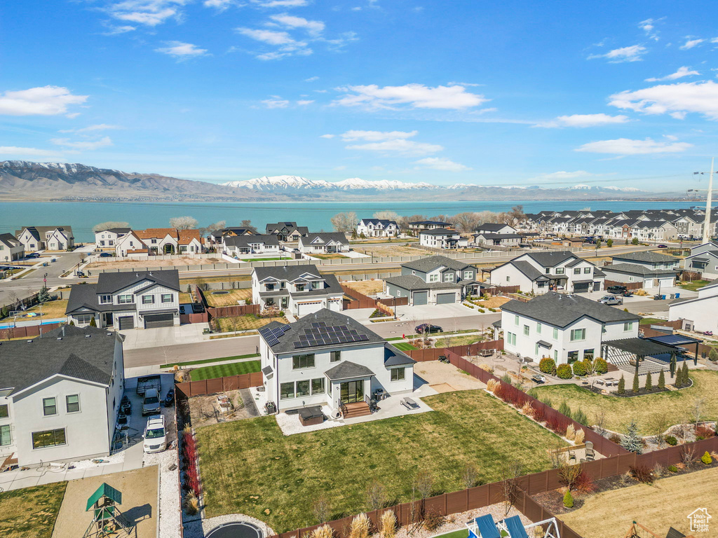 Drone / aerial view with a residential view and a water and mountain view