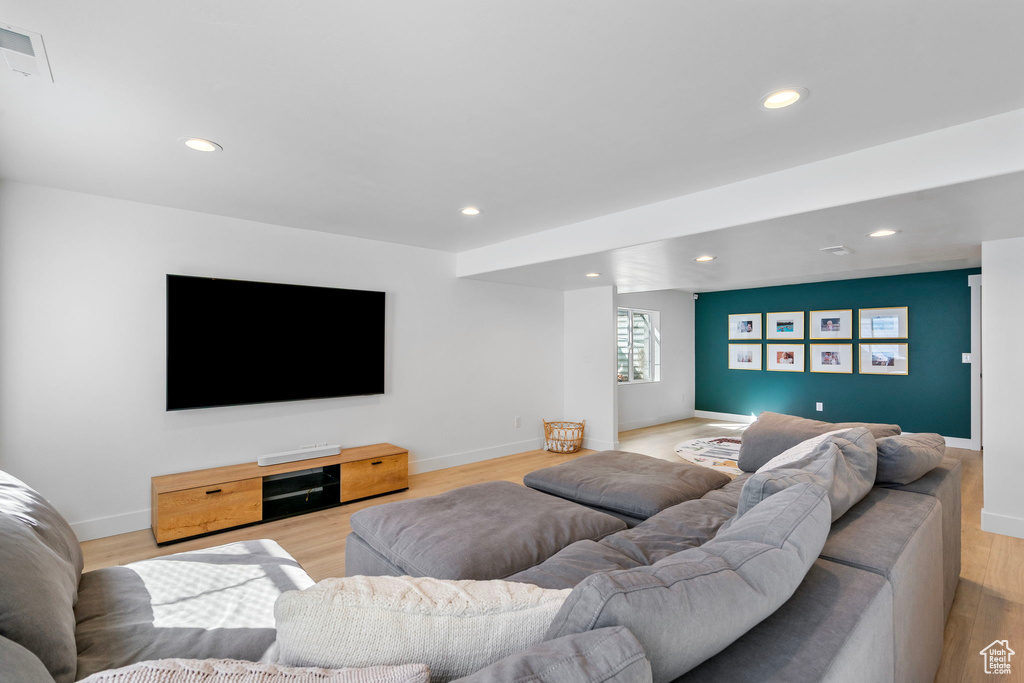 Living area featuring light wood finished floors, visible vents, and recessed lighting