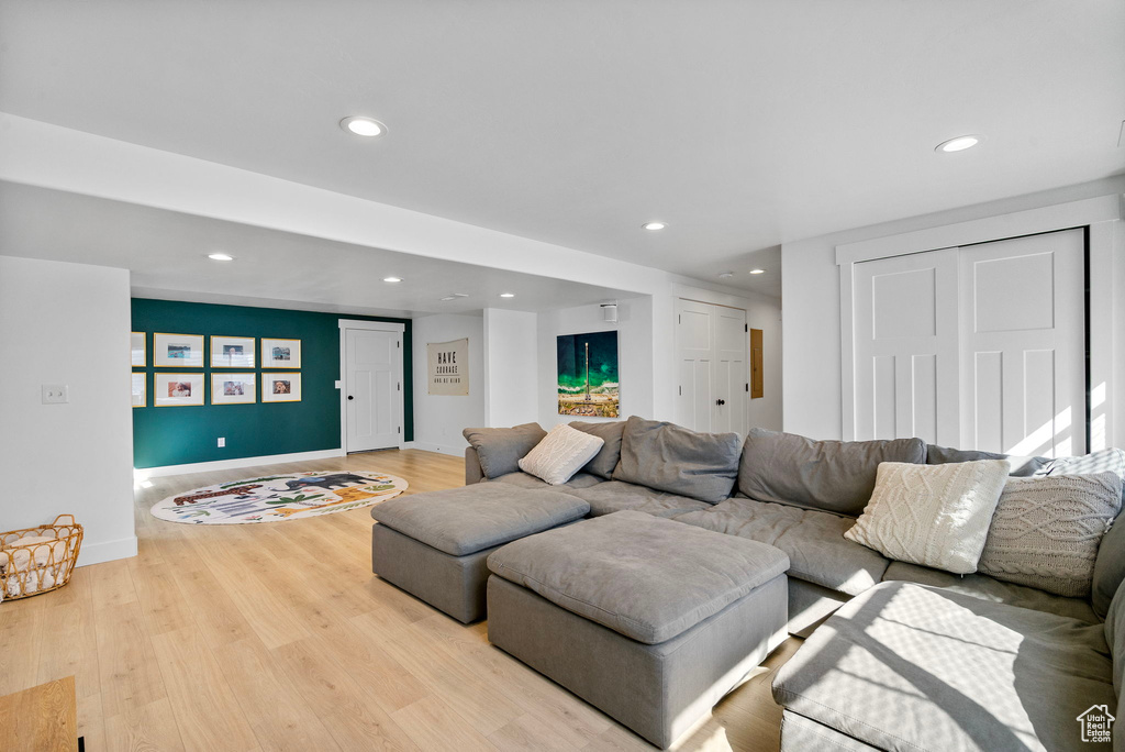 Living area featuring light wood-style flooring, baseboards, and recessed lighting
