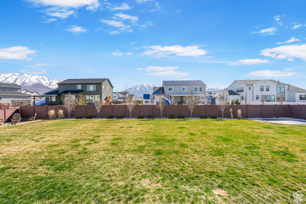 View of yard featuring a residential view, fence, and a mountain view