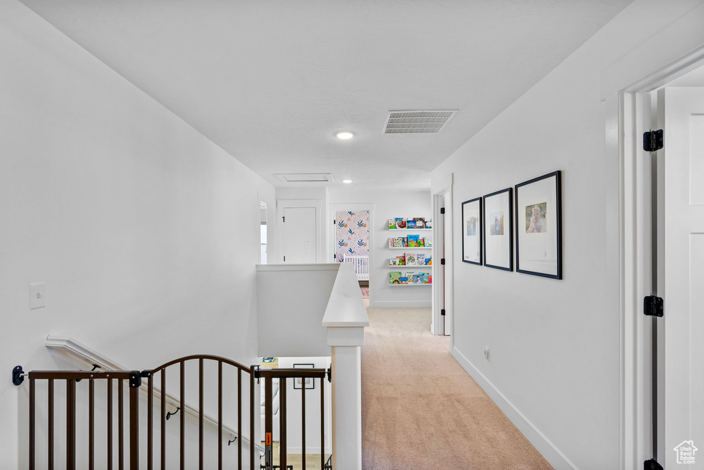 Hall featuring an upstairs landing, baseboards, light colored carpet, visible vents, and recessed lighting