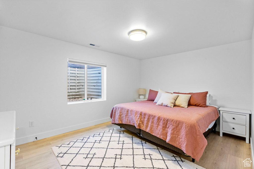 Bedroom featuring baseboards, visible vents, and light wood-type flooring