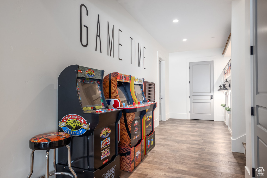 Hall with wood finished floors, recessed lighting, and baseboards