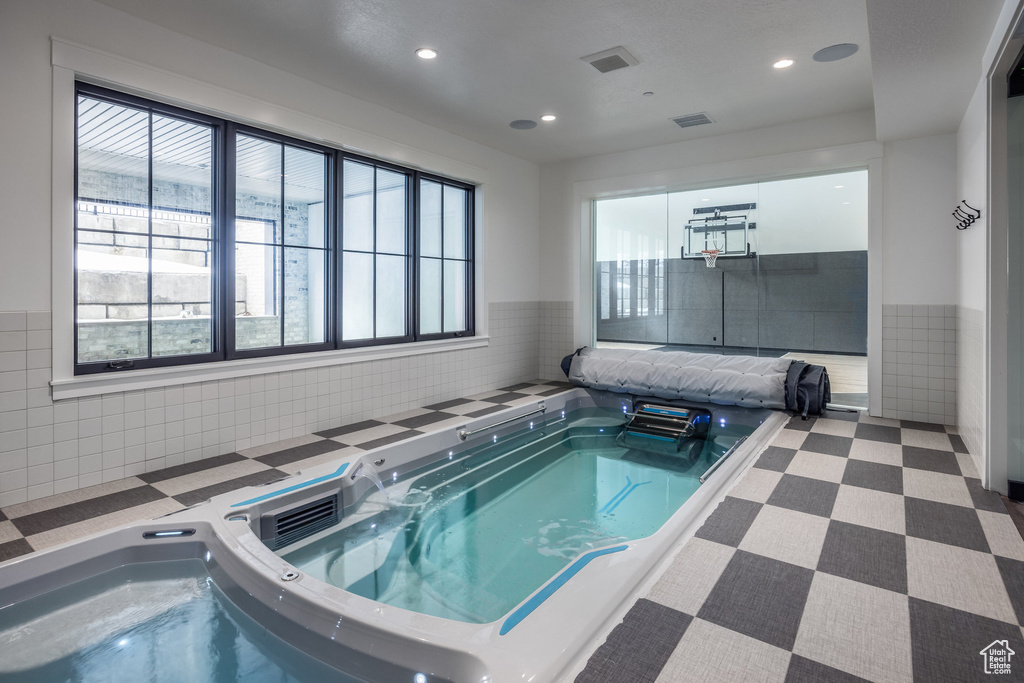 View of pool with an indoor hot tub