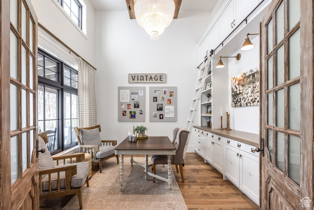Office with a high ceiling and wood finished floors