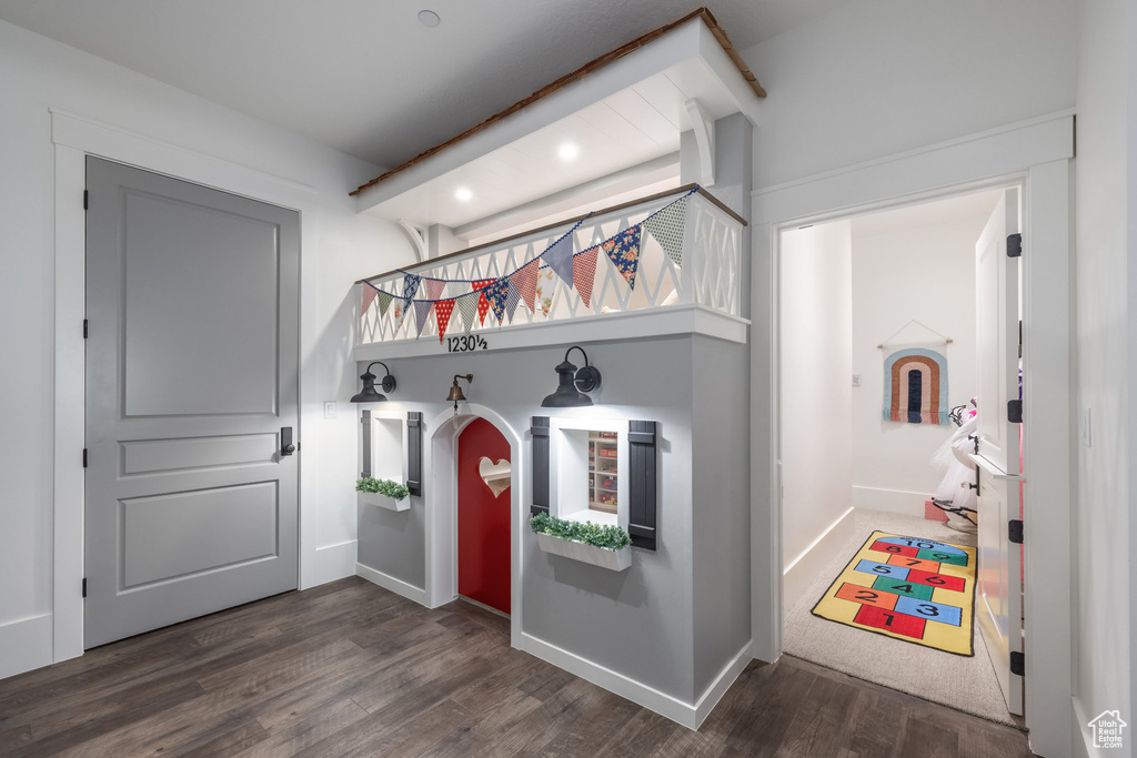 Mudroom featuring wood finished floors, recessed lighting, baseboards, beam ceiling, and arched walkways