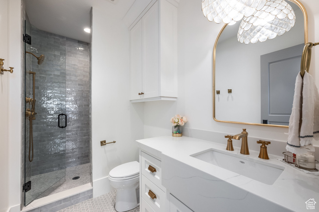 Full bath featuring toilet, vanity, a shower stall, and tile patterned flooring
