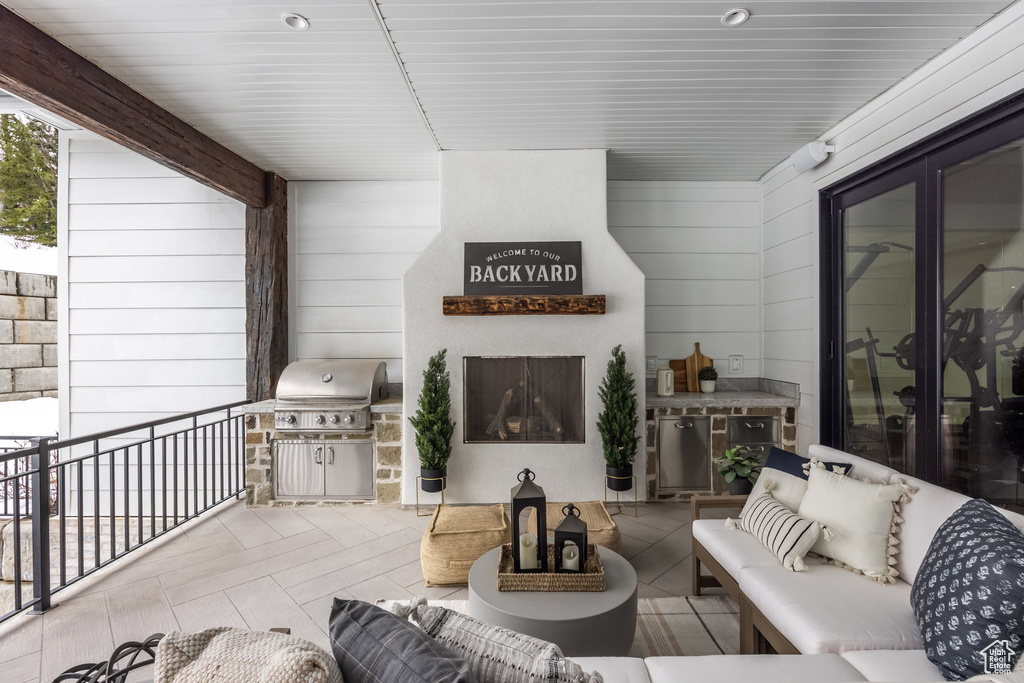 View of patio with an outdoor living space and grilling area
