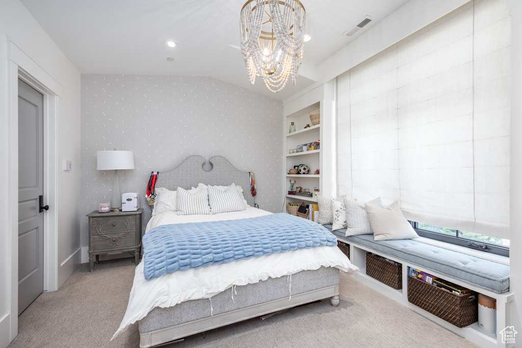 Bedroom featuring a chandelier, carpet flooring, vaulted ceiling, and wallpapered walls