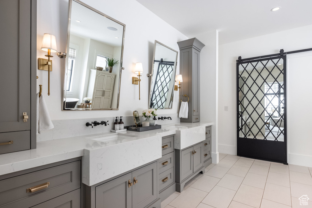 Full bathroom featuring vanity, tile patterned floors, baseboards, and recessed lighting