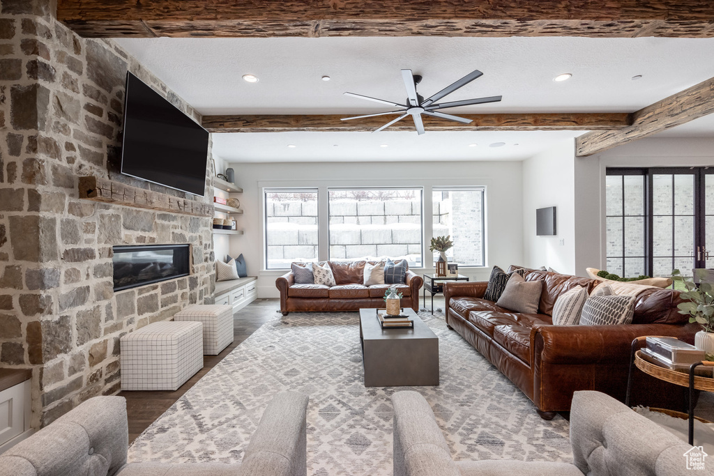 Living room featuring ceiling fan, beam ceiling, recessed lighting, light wood finished floors, and a fireplace